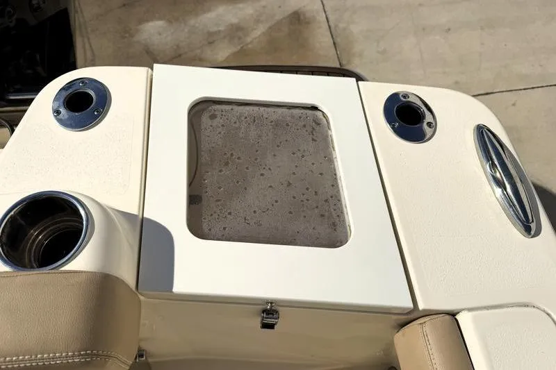 Slide: The Image of 2023 Scout 215 Dorado boat interior with cup holders and storage compartment. - 16