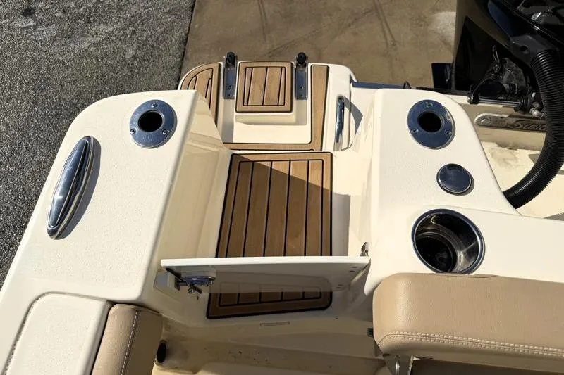 Slide: The Image of 2023 Scout 215 Dorado boat deck with teak flooring and stainless steel fixtures. - 18