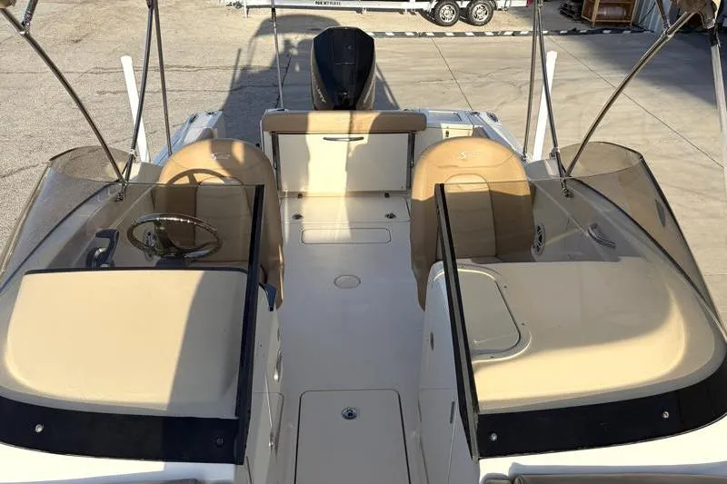 Slide: The Image of 2023 Scout 215 Dorado boat interior with tan seating and dual consoles. - 20