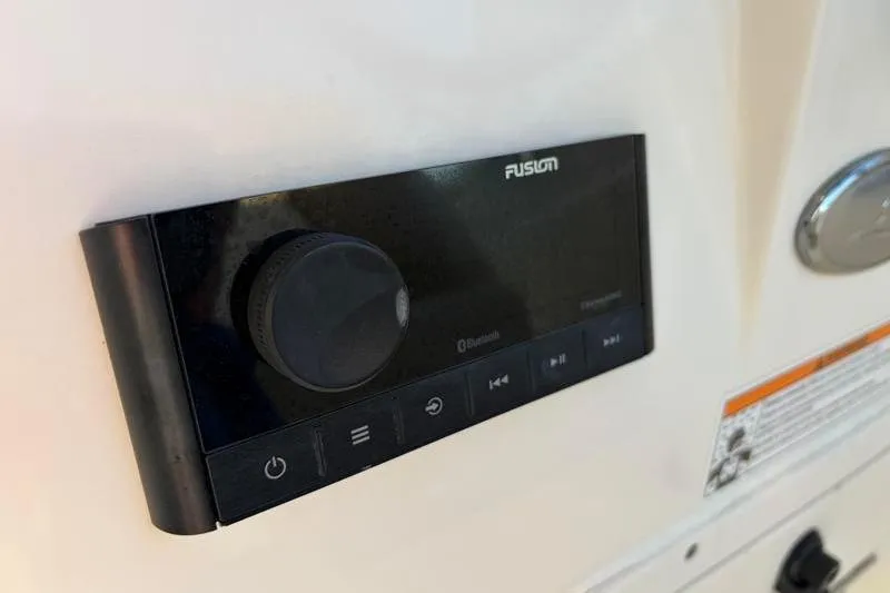 Slide: The Image of Fusion audio control panel on 2023 Scout 215 Dorado boat dashboard. - 25