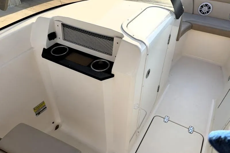 Slide: The Image of 2023 Scout 215 Dorado boat interior with cup holders and seating area. - 28