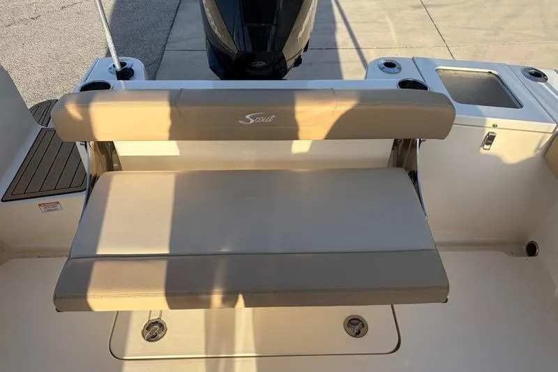 Slide: The Image of 2023 Scout 215 Dorado boat seating area with beige cushions and cup holders. - 32