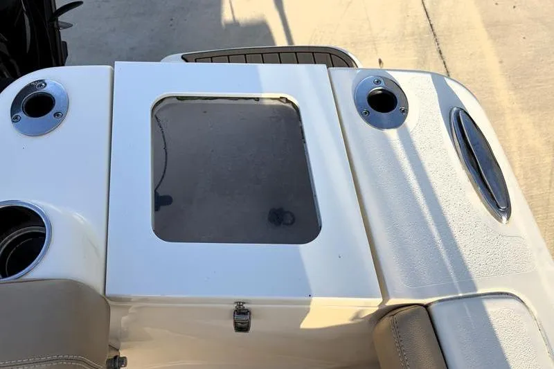 Slide: The Image of 2023 Scout 215 Dorado boat deck with cup holders and storage compartment. - 33