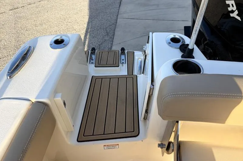 Slide: The Image of 2023 Scout 215 Dorado boat deck with cup holders and teak flooring. - 34