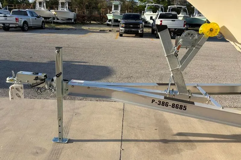 Slide: The Image of 2023 Scout 215 Dorado boat trailer in parking lot with trucks and boats in background. - 35