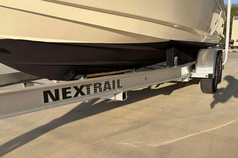 Slide: The Image of 2023 Scout 215 Dorado boat on Nextrail trailer, parked on concrete surface. - 36
