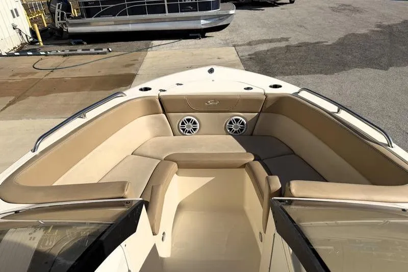 Slide: The Image of 2023 Scout 215 Dorado boat interior with beige seating and speakers. - 6