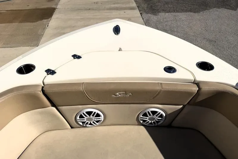 Slide: The Image of 2023 Scout 215 Dorado boat interior with beige seating and built-in speakers. - 7