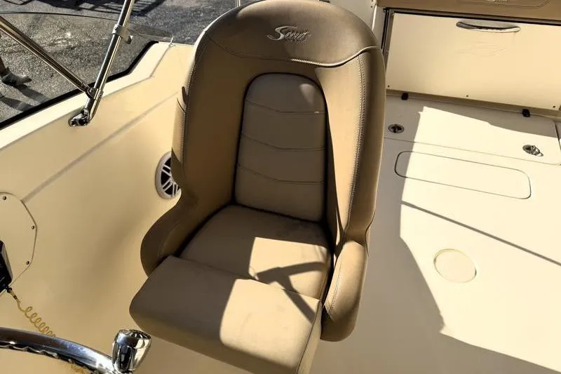 Slide: The Image of 2023 Scout 215 Dorado boat seat, beige leather, sunlight casting shadows. - 9