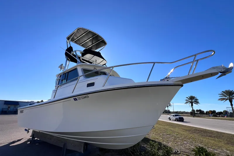 Slide: The Image of 2023 Parker 2820 XLD Sport Cabin boat on display under clear blue sky. - 16
