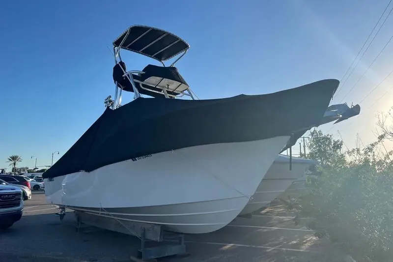 Slide: The Image of 2023 Parker 2820 XLD Sport Cabin boat with cover in a parking lot. - 17