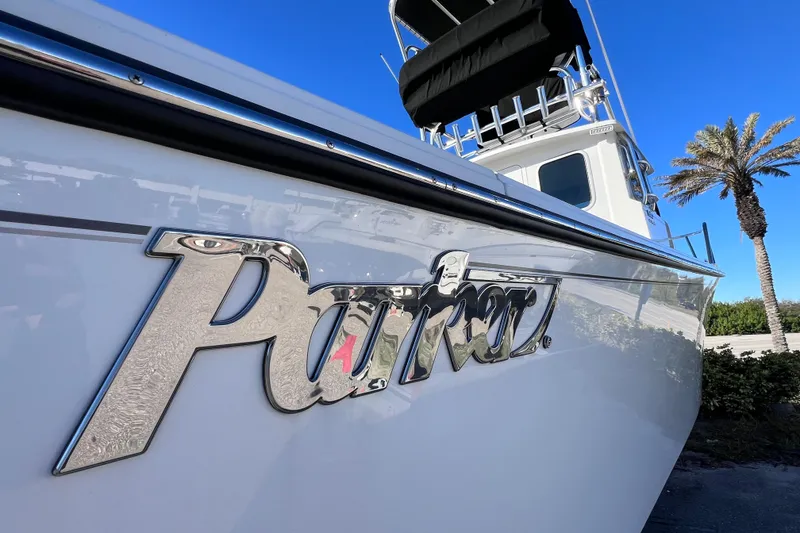 Slide: The Image of 2023 Parker 2820 XLD Sport Cabin boat with chrome logo, clear blue sky background. - 18