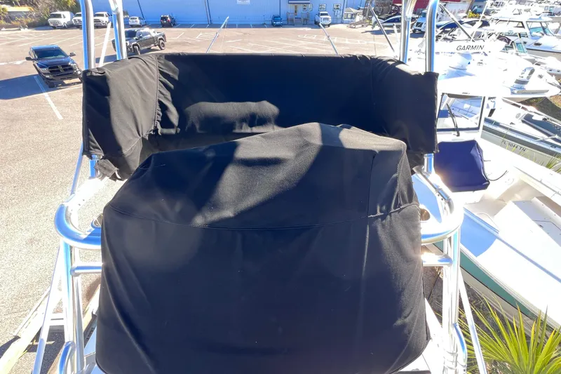 Slide: The Image of 2023 Parker 2820 XLD Sport Cabin boat with black protective covers in a marina. - 21