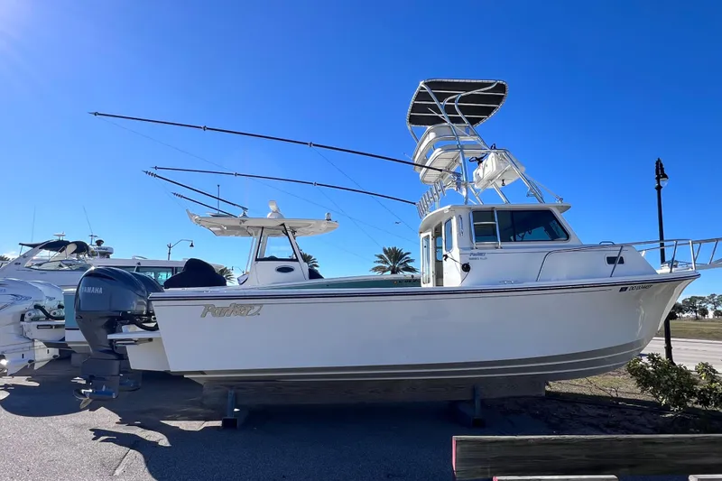 Slide: The Image of 2023 Parker 2820 XLD Sport Cabin boat with Yamaha engine, parked outdoors. - 25
