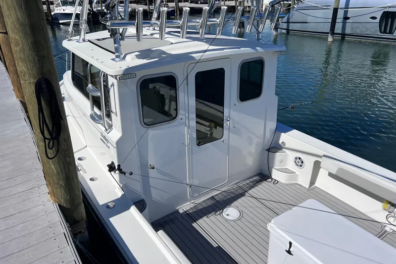 Slide: The Image of 2023 Parker 2820 XLD Sport Cabin boat docked at marina. - 29