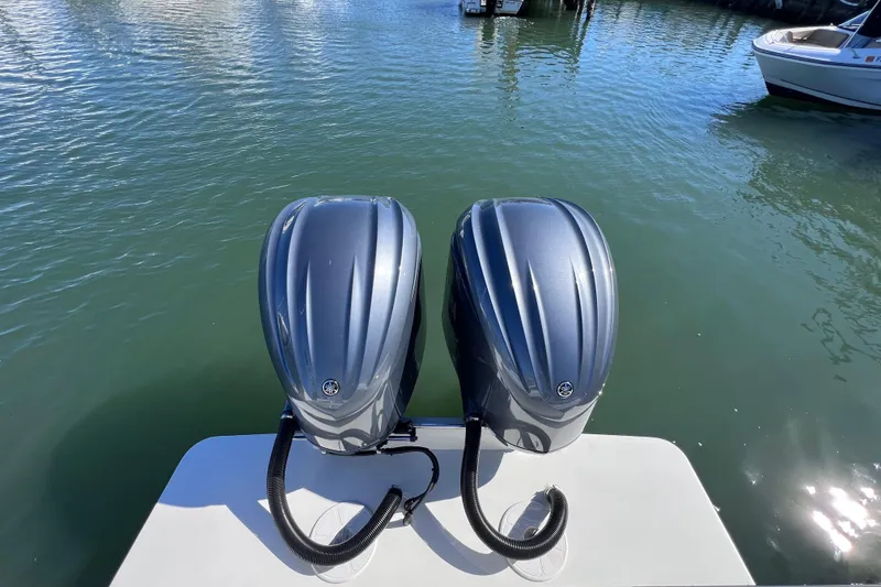 Slide: The Image of Twin outboard motors on 2023 Parker 2820 XLD Sport Cabin boat in calm waters. - 30