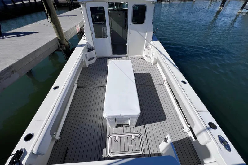 Slide: The Image of 2023 Parker 2820 XLD Sport Cabin boat docked, featuring spacious deck and modern design. - 31