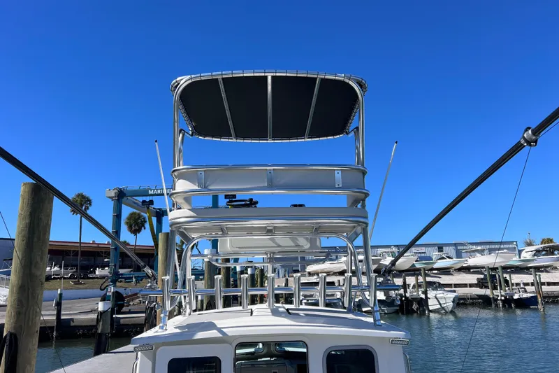 Slide: The Image of 2023 Parker 2820 XLD Sport Cabin boat docked at marina under clear blue sky. - 32