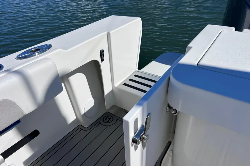 Slide: The Image of 2023 Parker 2820 XLD Sport Cabin boat deck with open door, near water. - 35
