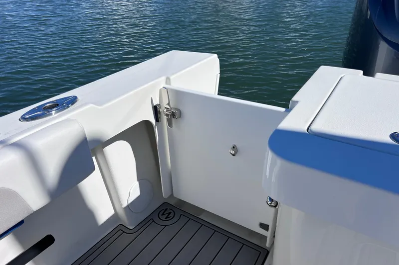 Slide: The Image of 2023 Parker 2820 XLD Sport Cabin boat deck with open door, near water. - 36