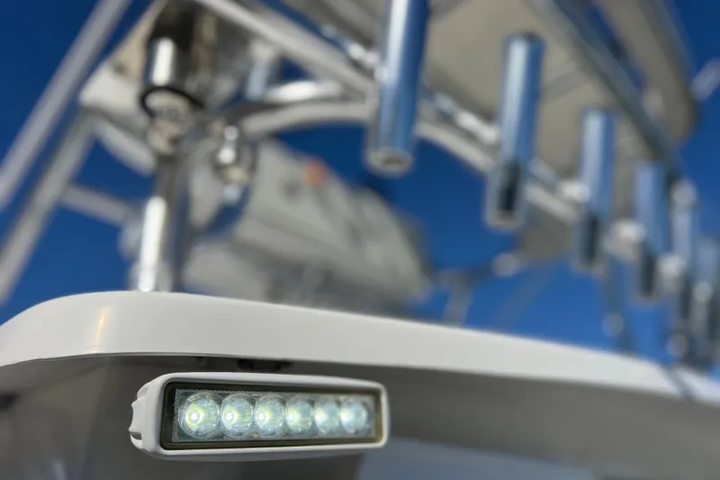 Slide: The Image of Close-up of 2023 Parker 2820 XLD Sport Cabin boat's LED light and rod holders. - 46