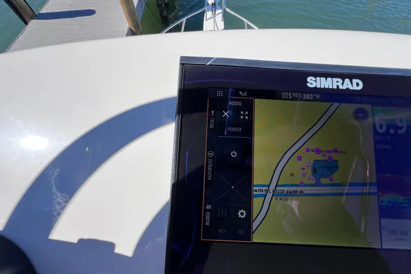 Slide: The Image of Simrad navigation system on 2023 Parker 2820 XLD Sport Cabin boat, docked by water. - 59