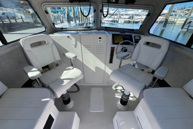Slide: The Image of 2023 Parker 2820 XLD Sport Cabin interior with white seating and control panel. - 64