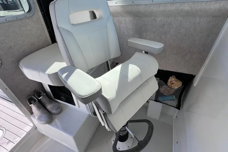 Slide: The Image of 2023 Parker 2820 XLD Sport Cabin interior with white captain's chair and storage area. - 66