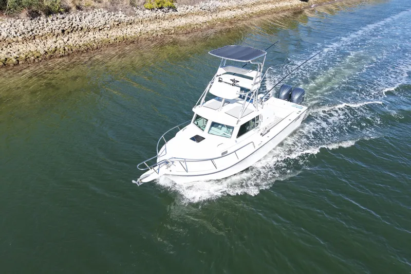 Slide: The Image of 2023 Parker 2820 XLD Sport Cabin boat cruising on a calm waterway. - 7