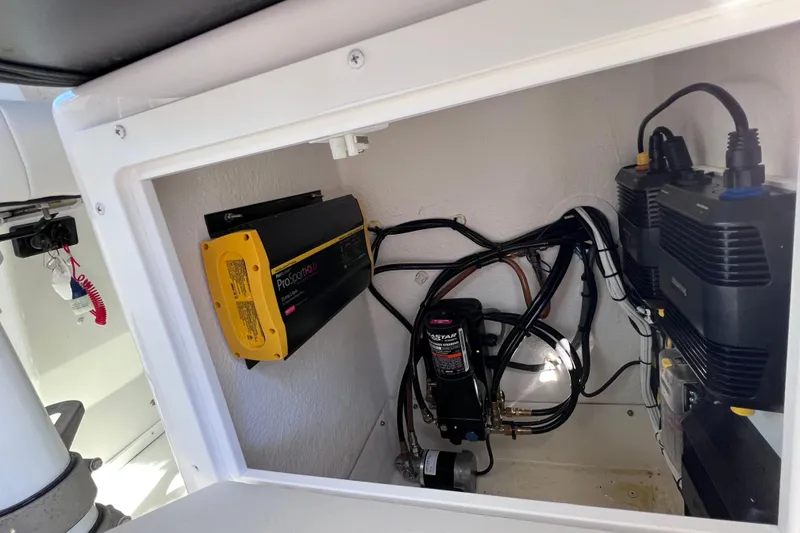 Slide: The Image of Electrical components inside a 2023 Parker 2820 XLD Sport Cabin boat compartment. - 71