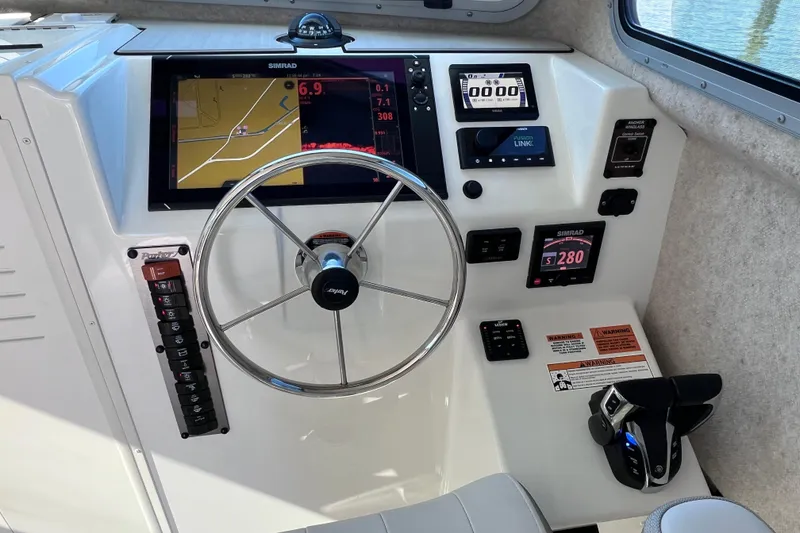 Slide: The Image of 2023 Parker 2820 XLD Sport Cabin helm with navigation and control systems. - 75