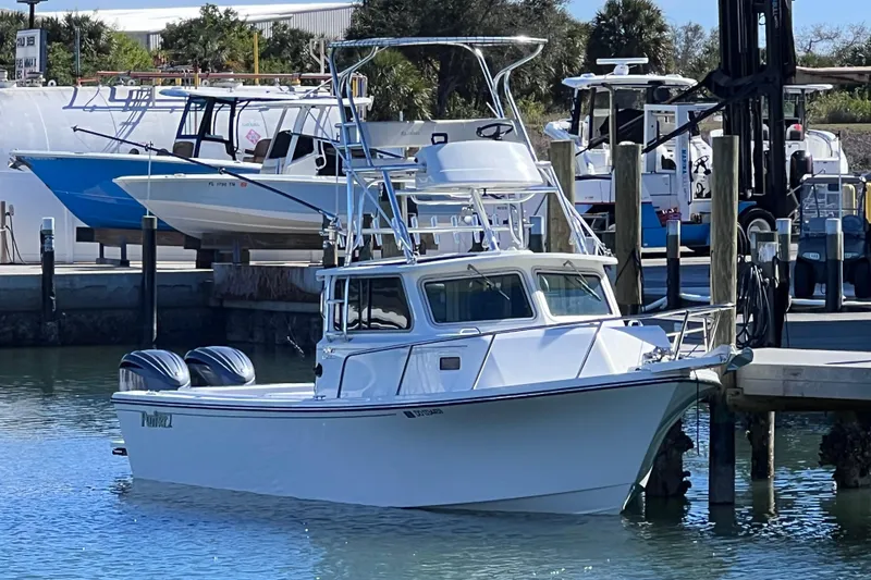 Slide: The Image of 2023 Parker 2820 XLD Sport Cabin boat docked at marina. - 8