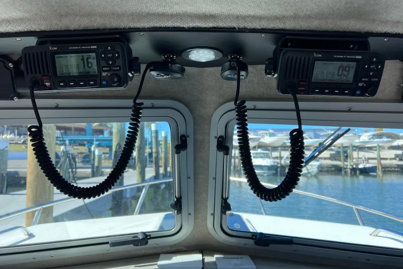 Slide: The Image of Interior view of 2023 Parker 2820 XLD Sport Cabin with marine radios and dockside scenery. - 81