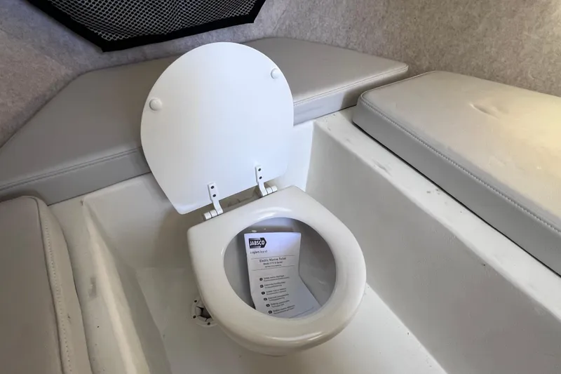 Slide: The Image of 2023 Parker 2820 XLD Sport Cabin interior with marine toilet and cushioned seating. - 84