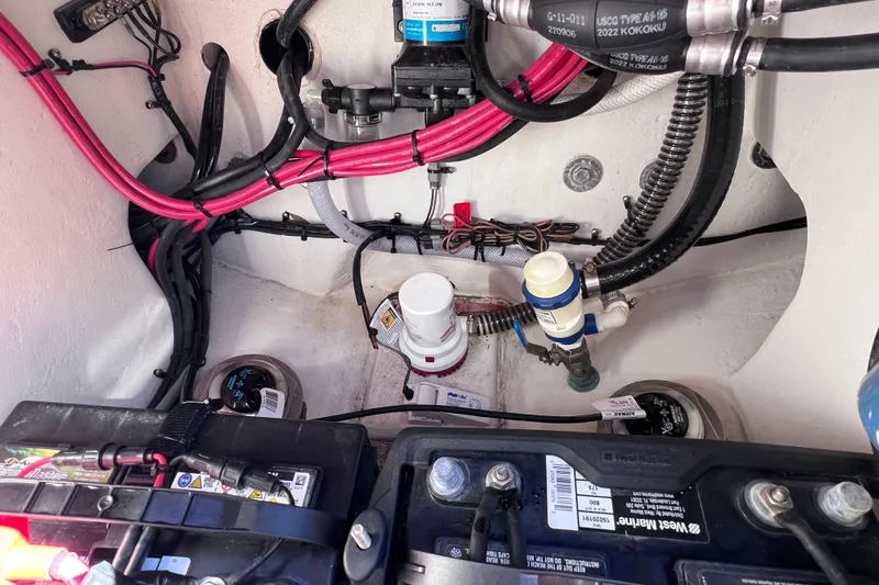 Slide: The Image of 2023 Parker 2820 XLD Sport Cabin engine compartment with wiring and battery setup. - 96