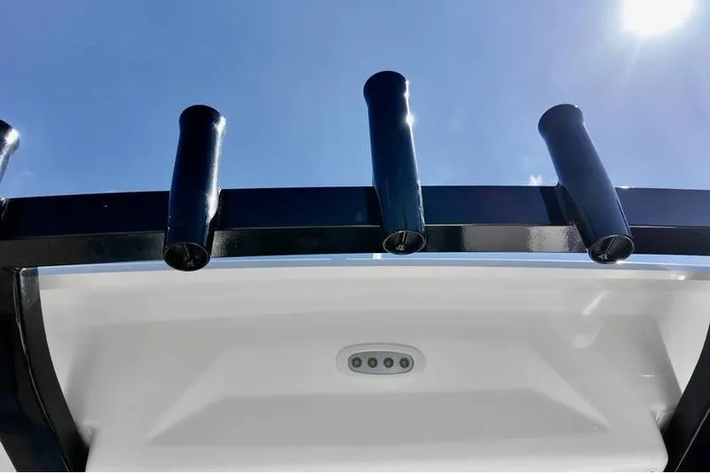 Slide: The Image of 2026 Sea Fox 268 Commander boat rod holders against clear blue sky. - 11