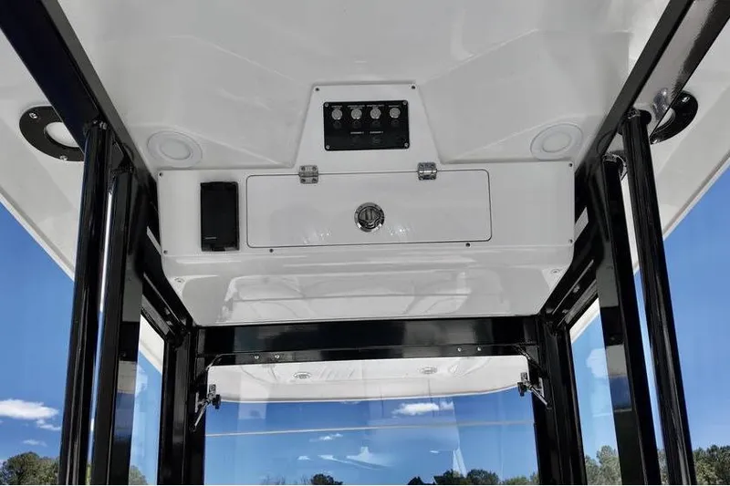 Slide: The Image of 2026 Sea Fox 268 Commander boat interior ceiling with control panel and storage. - 12