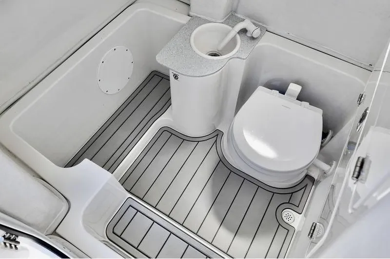 Slide: The Image of 2026 Sea Fox 268 Commander boat bathroom with toilet and sink, featuring sleek design. - 13
