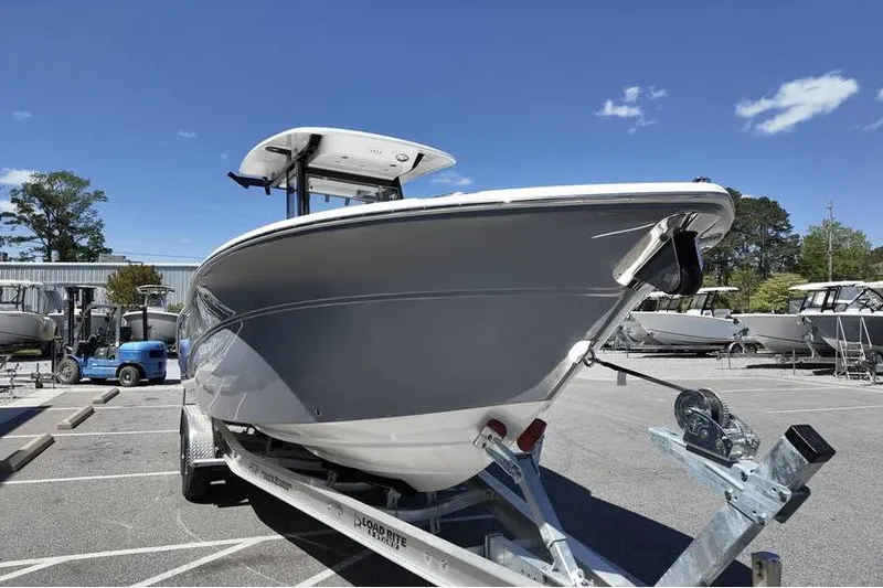 Slide: The Image of 2026 Sea Fox 268 Commander boat on trailer under clear blue sky. - 2