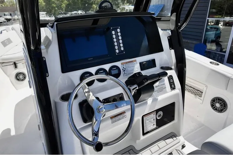 Slide: The Image of 2026 Sea Fox 268 Commander boat dashboard with steering wheel and control panel. - 6