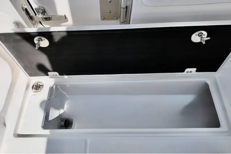 Slide: The Image of Storage compartment on 2026 Sea Fox 268 Commander boat, featuring secure latches and drainage system. - 9