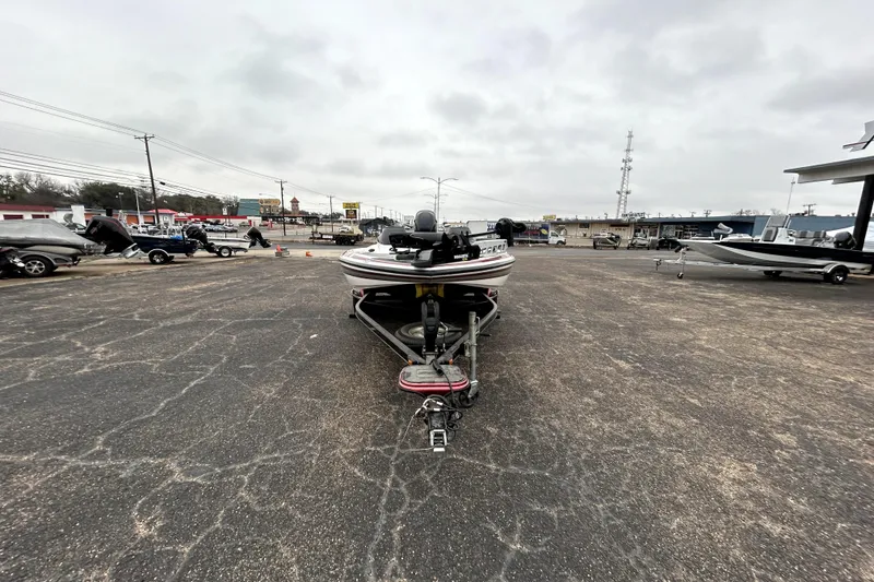 Slide: The Image of 2010 Skeeter 20i boat on trailer in parking lot, overcast sky. - 2