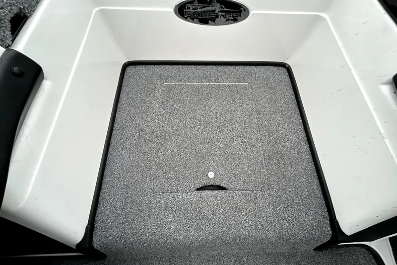 Slide: The Image of 2010 Skeeter 20i boat deck with textured gray surface and storage compartment. - 21