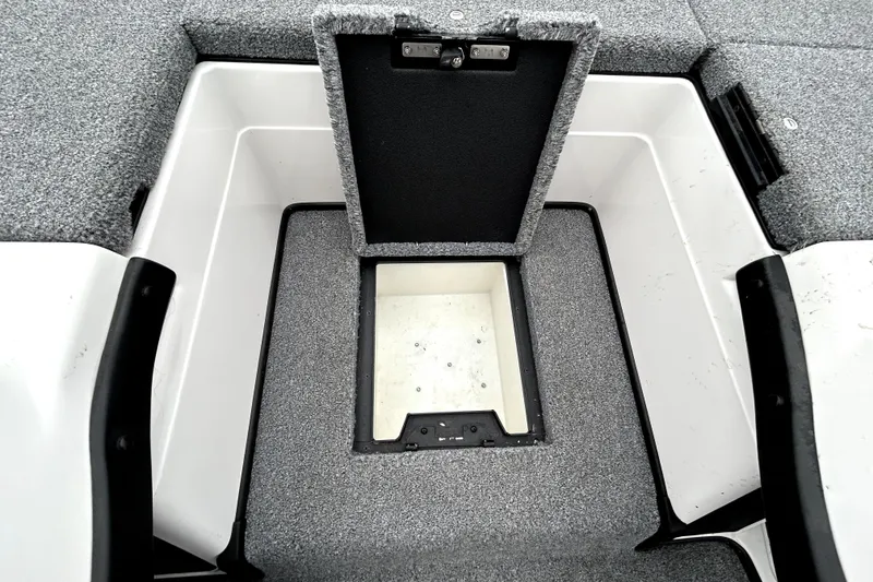 Slide: The Image of 2010 Skeeter 20i boat storage compartment with open lid, showcasing interior space. - 22