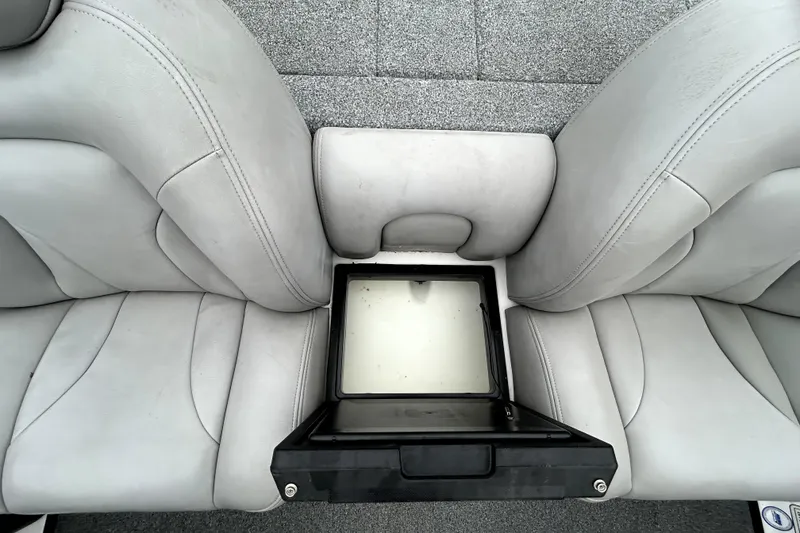 Slide: The Image of 2010 Skeeter 20i boat interior with gray seats and storage compartment. - 26