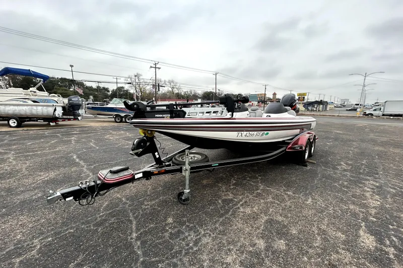 Slide: The Image of 2010 Skeeter 20i boat on trailer in parking lot, overcast sky. - 3