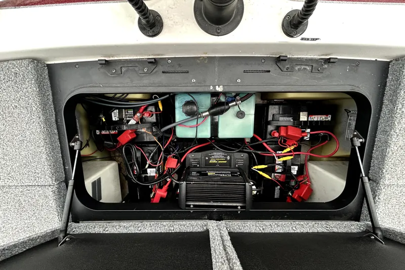 Slide: The Image of 2010 Skeeter 20i boat battery compartment with wiring and components. - 35
