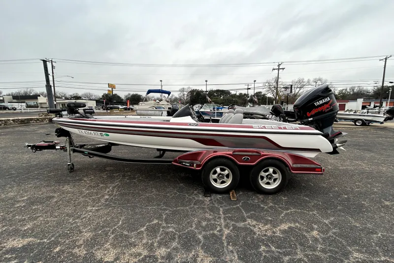 Slide: The Image of 2010 Skeeter 20i bass boat with Yamaha engine on a trailer. - 4