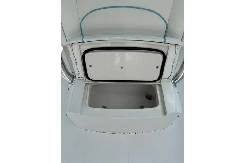 Slide: The Image of Open storage compartment on a 2014 Jupiter 34 boat, featuring a white interior. - 12