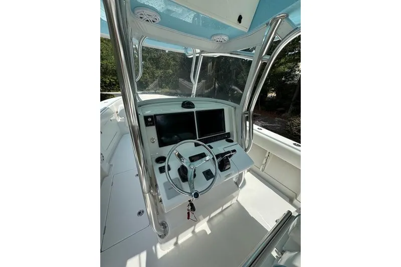 Slide: The Image of 2014 Jupiter 34 boat cockpit with steering wheel and dual screens. - 14